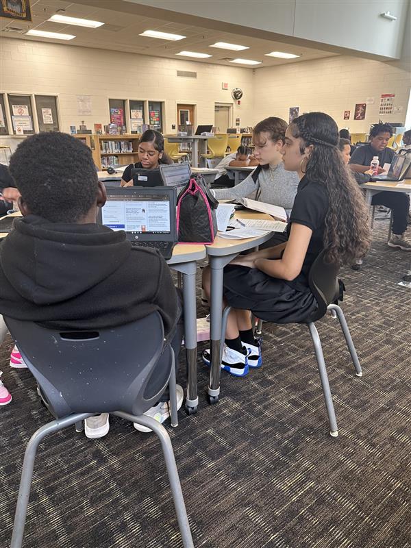 students working on computers in library